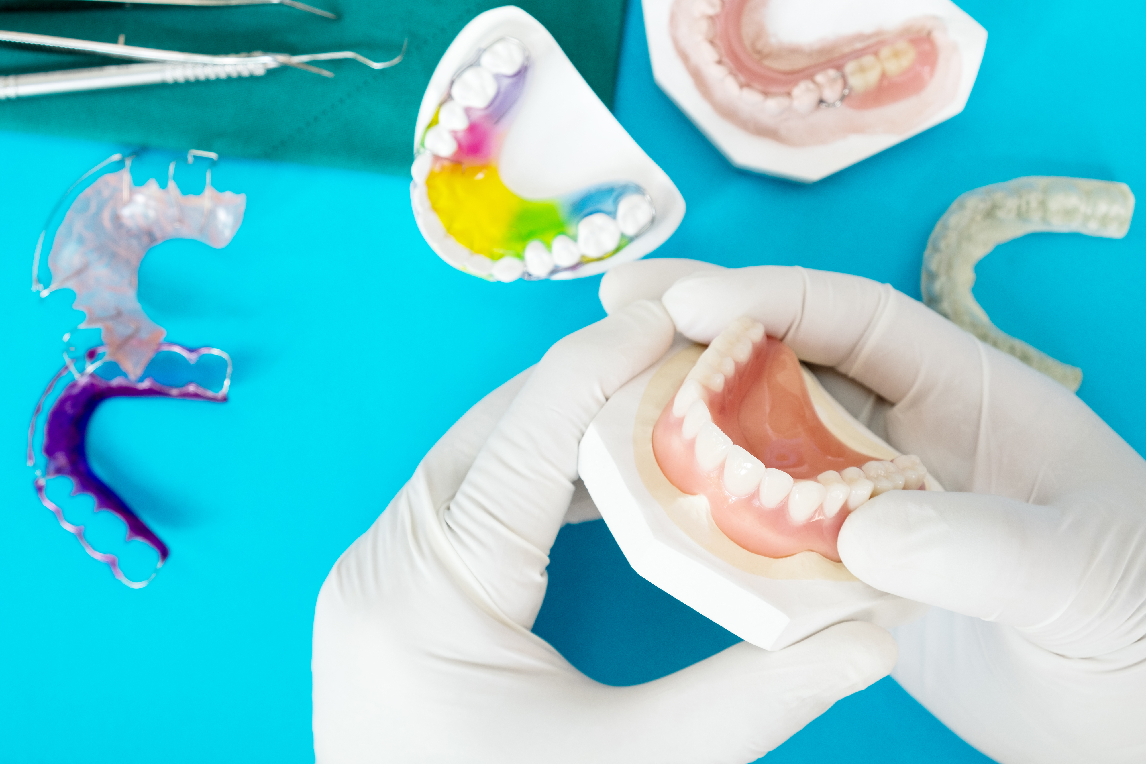 Complete denture or full denture on blue background.
